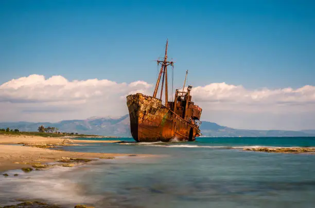 Photo of Rusty and abandoned shipwreck stands on a coastline near Gythio in Lakonia.