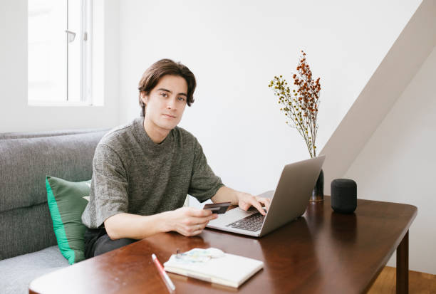 istock Young Man Shopping Online 1217814088