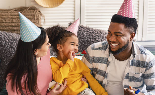 istock Multiracial family in caps blowing in fifes 1217815790