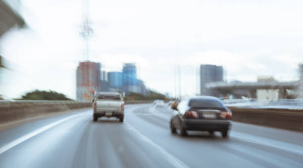 istock blurred car on road, bokeh background 1217817339