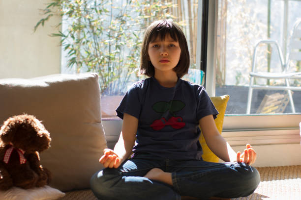istock meditating child in lockdown practicing mindfulness and yoga while covid19 1217817417