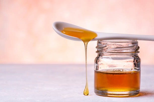 istock Drops of honey from the spoon 1217817596