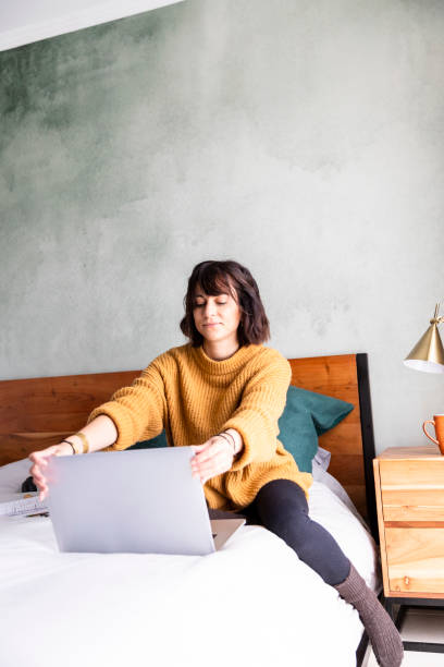 istock Young woman opens laptop working from home 1217818998