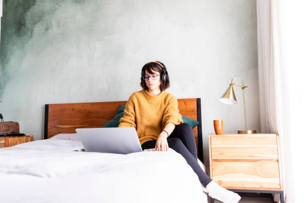 istock Wide shot bored woman working on laptop 1217819037