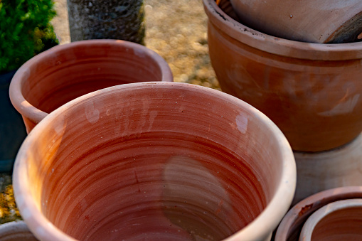 Terracotta plant pots on a garden supplies market stall.