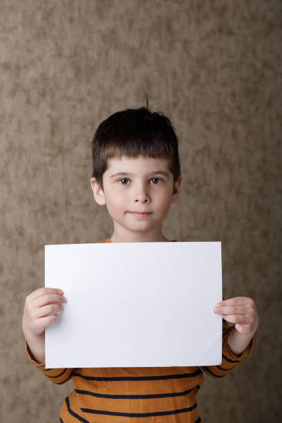 istock boy, white paper . Place for text. Mockup. 1217821218