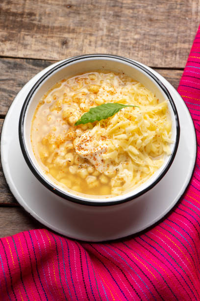 istock Mexican corn grain boiled also called esquites with cheese and mayonnaise on wooden background 1217821597
