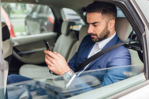 istock Handsome businessman riding in the car 1217822283