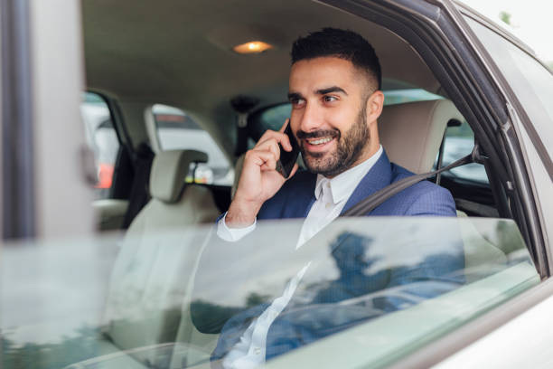 istock Handsome businessman riding in the car 1217822318