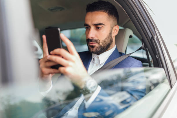 istock Handsome businessman riding in the car 1217822321