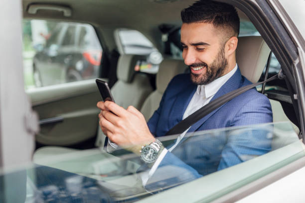 istock Handsome businessman riding in the car 1217822351