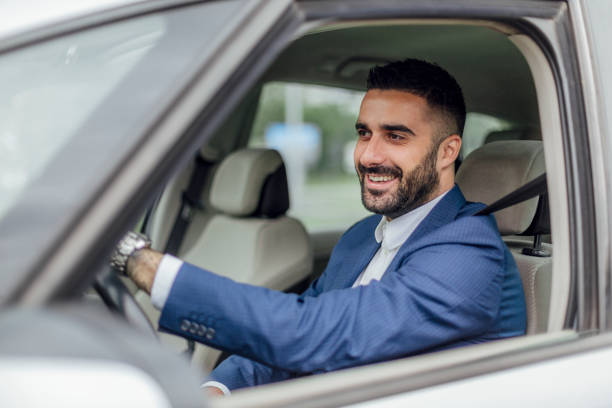 istock Young businessman driving a car 1217822572
