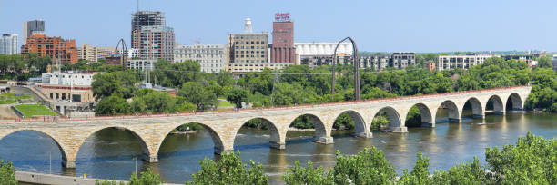 Stone Arch Bridge - Minneapolis Panoramic day time view of the Stone Arch bridge crossing the Mississippi river (Minneapolis, Minnesota). arch bridge photos stock pictures, royalty-free photos & images