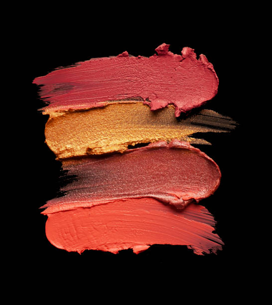 istock Bright red purple pink lipstick on black background 1217823566