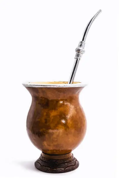 Photo of cup of mate, called chimarrão, from South America. White isolated background, utensil for mate herb , Brazilian bowl for mate. Typical drink from Brazil, Argentina, Uruguay and paraguay.