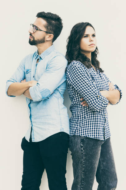 istock Sad unhappy couple standing back-to-back with arms crossed 1217824748