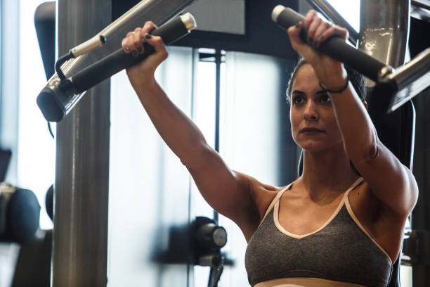 istock Muscular young woman strength training her upper body on chest press 1217825157