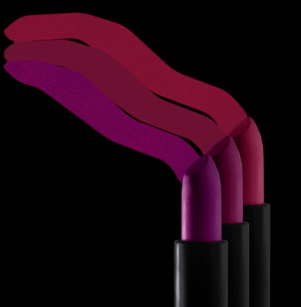 istock Bright red purple pink lipstick on black background 1217825489