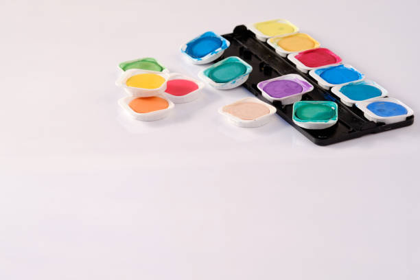 istock Colours of a watercolor box on white background 1217827053