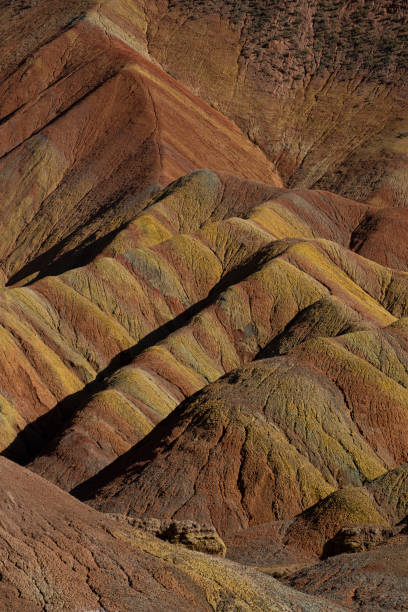 Colorful Zhangye Danxia National Geopark or China's Rainbow Mountains, Gansu, China Zhangye Danxia is known for the unusual colours of the rocks, which are smooth, sharp and several hundred meters tall. They are the result of deposits of sandstone and other minerals that occurred over 24 million years. zhangye danxia geopark china stock pictures, royalty-free photos & images