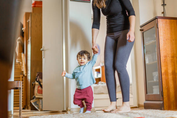 istock Baby boy, learning to walk with his mother 1217830548
