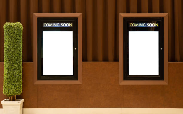 Empty isolated cinema poster panel Empty isolated cinema poster panel on the wall of theater walkway, white blank mockup movie frame with coming soon text for insert design film poster stock pictures, royalty-free photos & images