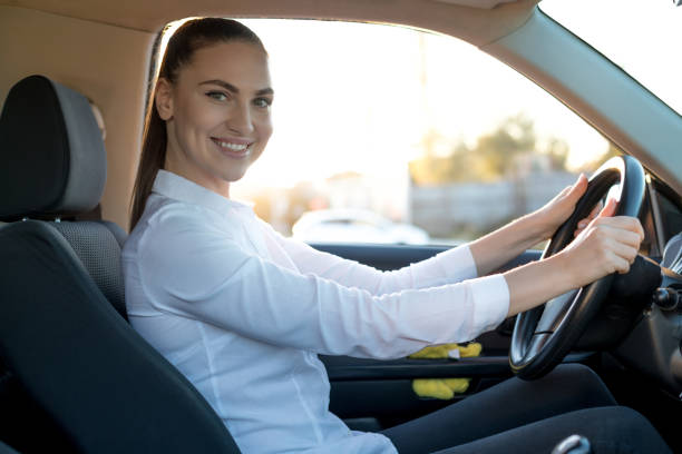 istock Young happy woman is driving a car 1217830828