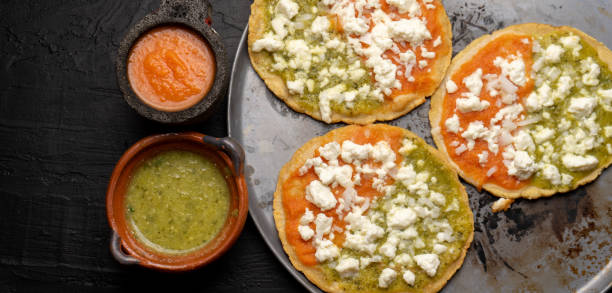 istock Mexican memela with green and red sauce on dark background 1217830956