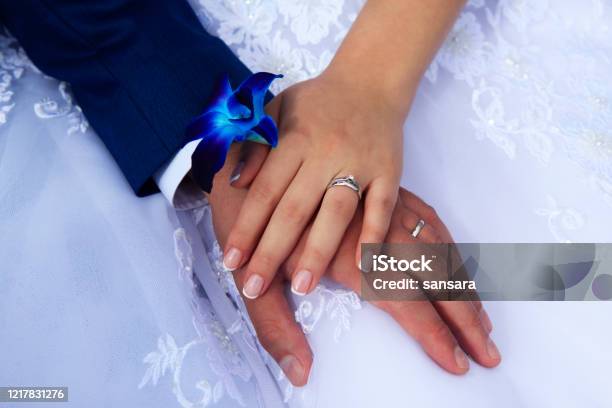 Hands Of The Bride And Groom On The Background Of A Wedding Dress Stock Photo - Download Image Now