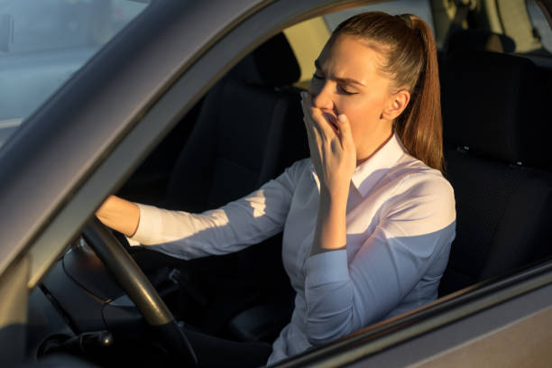istock Tired woman driving a car 1217832112