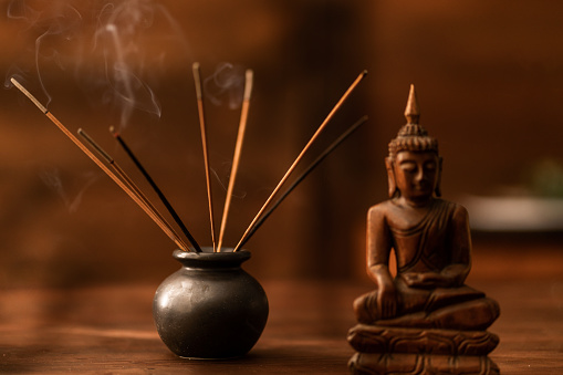 Buddha figurine wood table and background. Homemade meditation.Spiritual. Relaxation. Asia religion