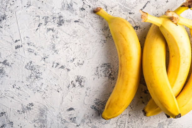 istock Banana fruits on white textured background, top view copy space 1217833977