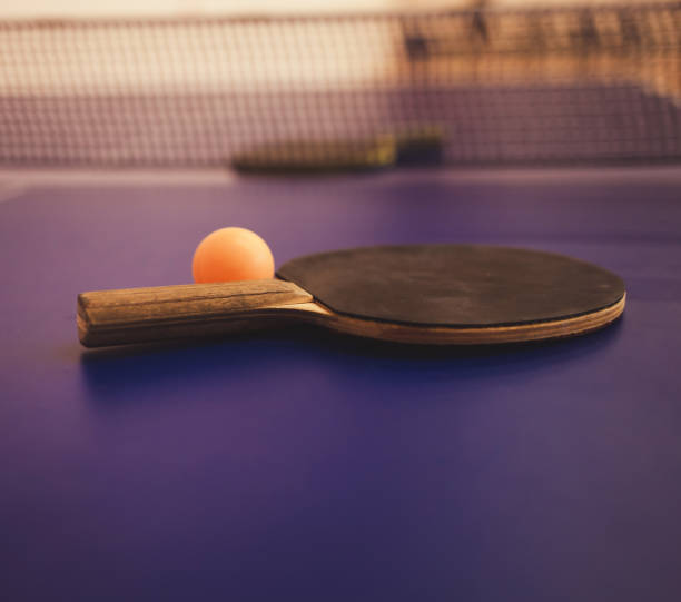 istock Tennis racket and ball on blue table 1217835382