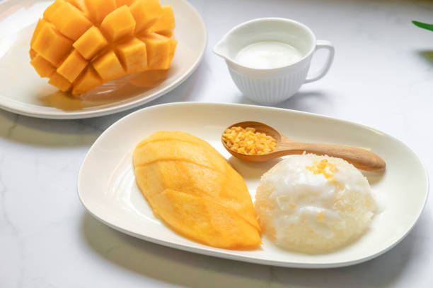 istock Thai sweet sticky rice with mango. Thai style tropical dessert, glutinous rice eat with mango. 1217835594