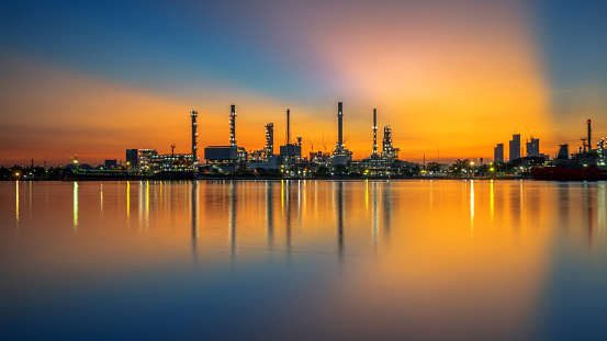 Oil refinery and sunrise at the Chao Phraya River, Thailand, petrochemical Industrial, oil refinery and oil industry.