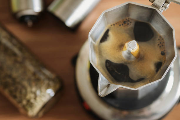 black coffee in moka pot espresso coffee in a stove top moka espresso pot ,moka coffee maker close-up moka stock pictures, royalty-free photos & images
