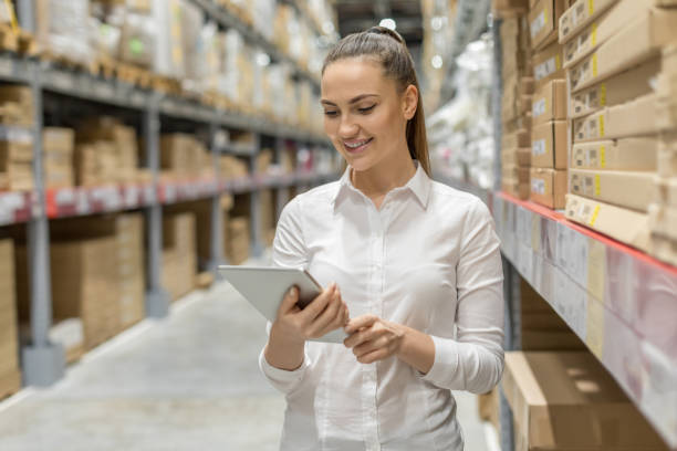 istock Young woman auditor working in warehouse store 1217838513