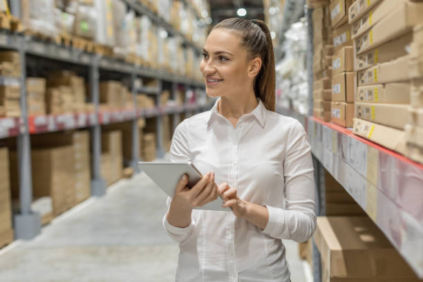 istock Young woman auditor working in warehouse store 1217839130