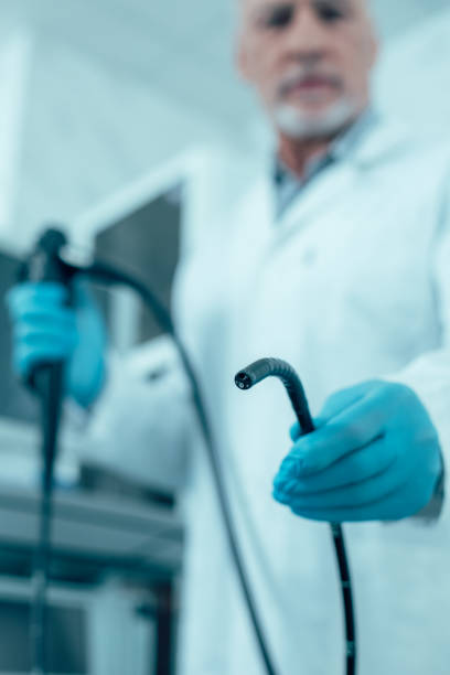 Medical examination endoscopy procedure in the hospital Selective focus of an endoscope in hand of a doctor stock photo gastroenterology photos stock pictures, royalty-free photos & images
