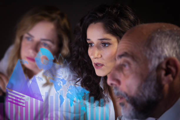 istock Focused business colleagues and virtual statistic graphics 1217839861