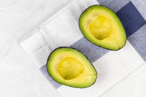 istock Avocado sliced on half on the kitchen dishcloth 1217840086