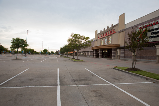 An parking lot stands empty in front of a shuttered Cinemark movie theatre. The movie theatre is closed due to Covid-19 pandemic. Cinemark USA, Inc. is an American movie theater chain owned by Cinemark Holdings, Inc. operating throughout the Americas and in Taiwan. It is headquartered in Plano, Texas, in the Dallas–Fort Worth area.