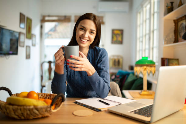 istock Beautiful young woman working from home 1217842000
