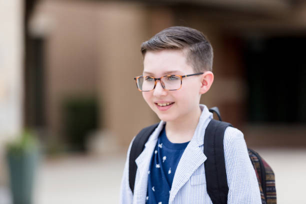 istock Elementary age boy wearing glasses walks to his ride 1217842016