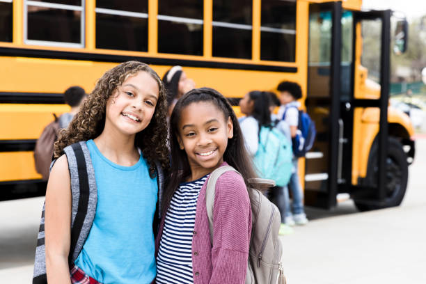 istock Two young girls pose for photo; one has cool attitude 1217842034