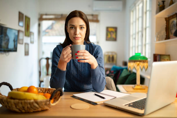 istock Beautiful young woman working from home 1217842086