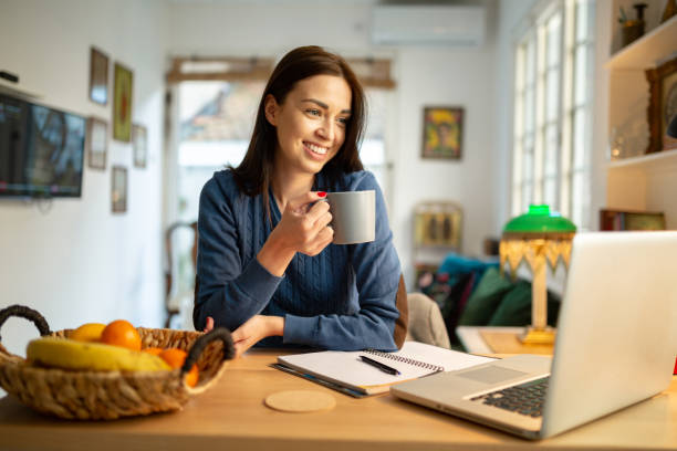 istock Beautiful young woman working from home 1217842668