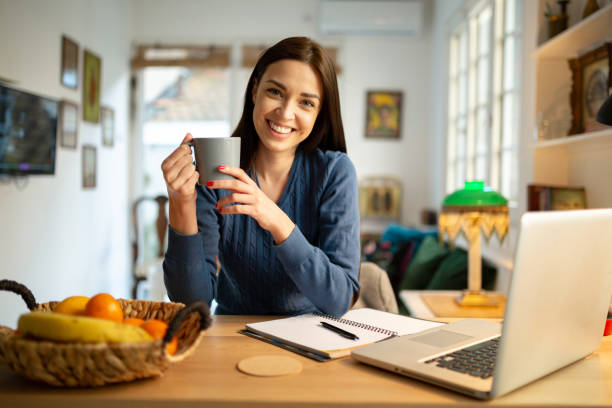 istock Beautiful young woman working from home 1217842690