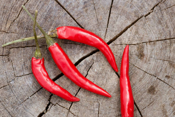 istock Red hot pepper lies on a wooden background 1217843889