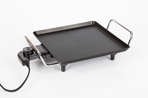 Electric griddle for cooking; photo on white background.